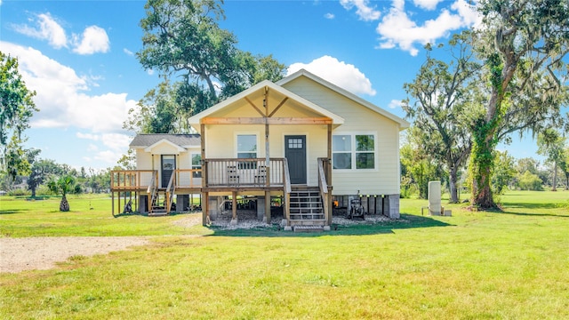 back of house with a lawn and a wooden deck