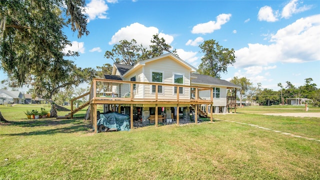 rear view of house with a yard and a deck