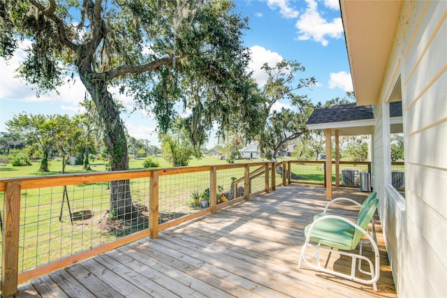 wooden terrace featuring a lawn