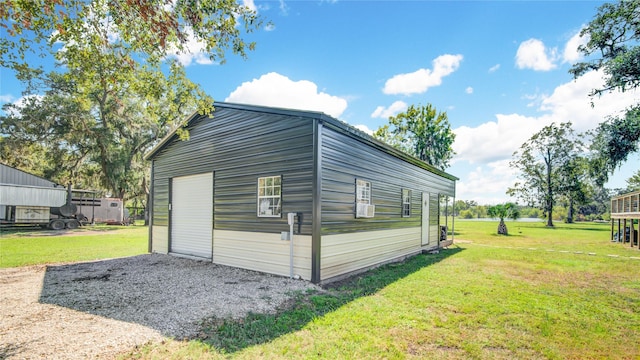 view of outbuilding with a yard and a garage