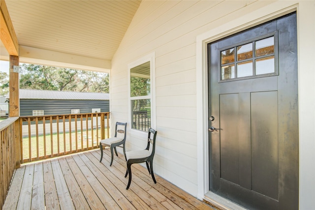 wooden terrace featuring covered porch