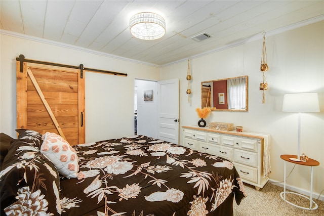 bedroom featuring a barn door, light colored carpet, and ornamental molding