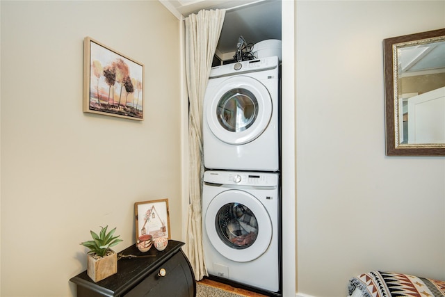 laundry room featuring stacked washer / drying machine