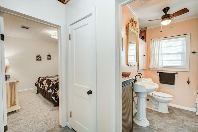 bathroom with toilet, ceiling fan, and crown molding