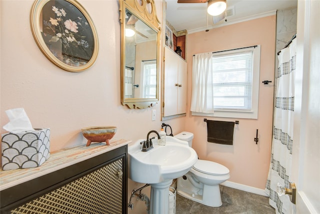 bathroom featuring sink, toilet, plenty of natural light, and ceiling fan