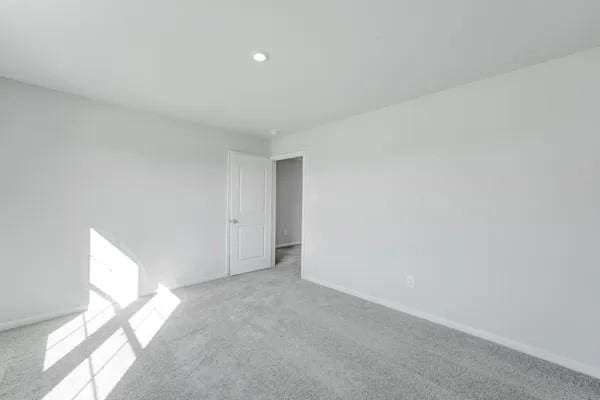 unfurnished room with light carpet