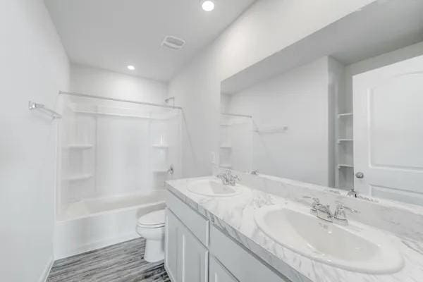 full bathroom featuring vanity, toilet, and shower / bathtub combination