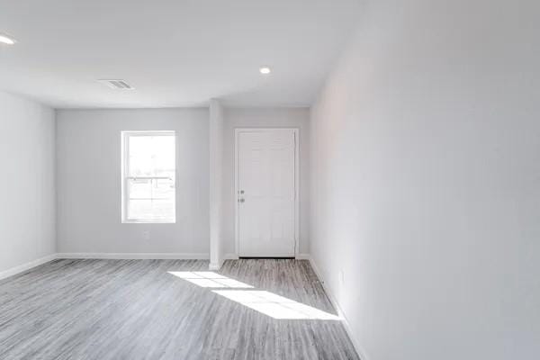 spare room with light hardwood / wood-style floors