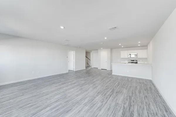 unfurnished living room with light wood-type flooring