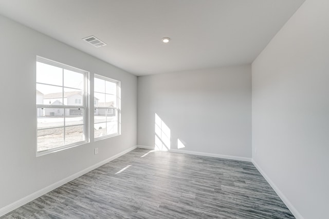 empty room with hardwood / wood-style floors