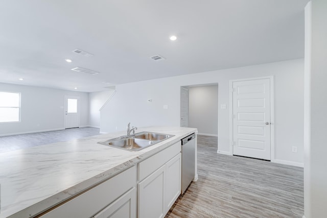 kitchen featuring white cabinets, dishwasher, light hardwood / wood-style floors, and sink