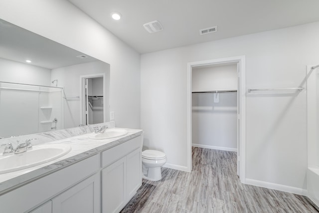 bathroom featuring wood-type flooring, vanity, and toilet