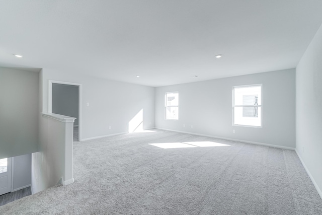 unfurnished room featuring light carpet