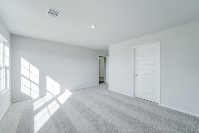 carpeted spare room with a healthy amount of sunlight