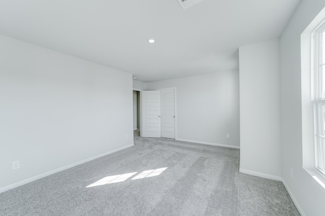 unfurnished room with light colored carpet