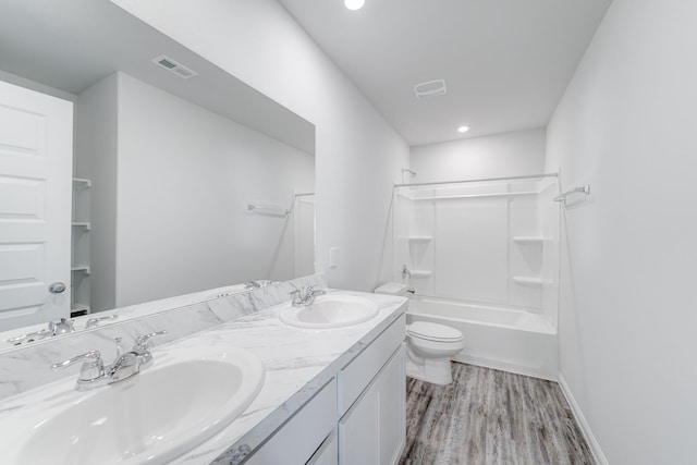 full bathroom with hardwood / wood-style flooring, vanity, toilet, and washtub / shower combination