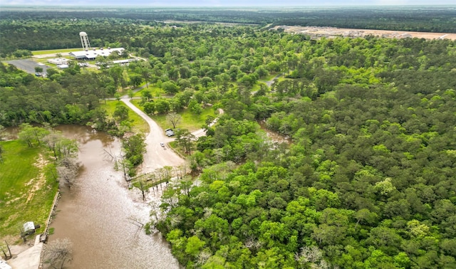 birds eye view of property featuring a water view and a view of trees