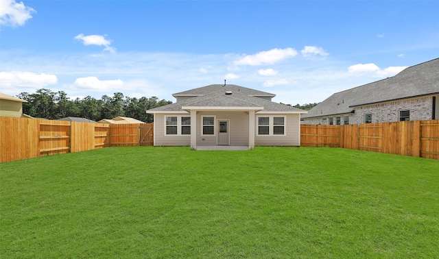 rear view of house with a yard and a patio area