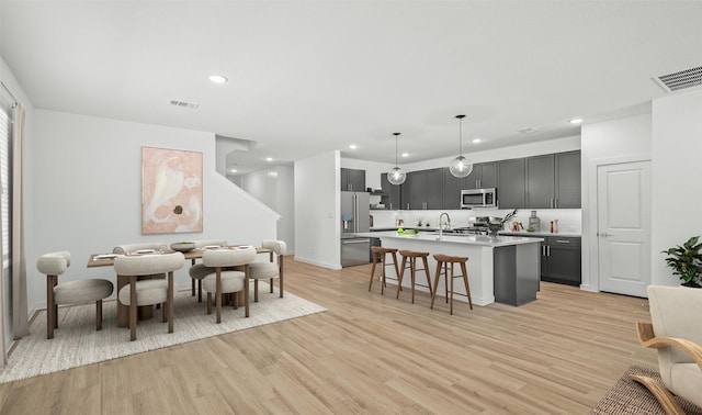 dining space featuring sink and light hardwood / wood-style flooring