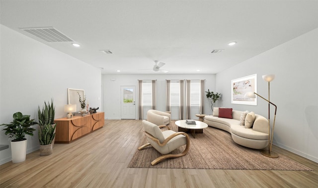 living room featuring ceiling fan and light wood-type flooring