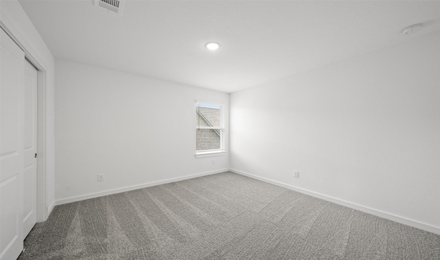 unfurnished bedroom with baseboards, a closet, visible vents, and carpet flooring