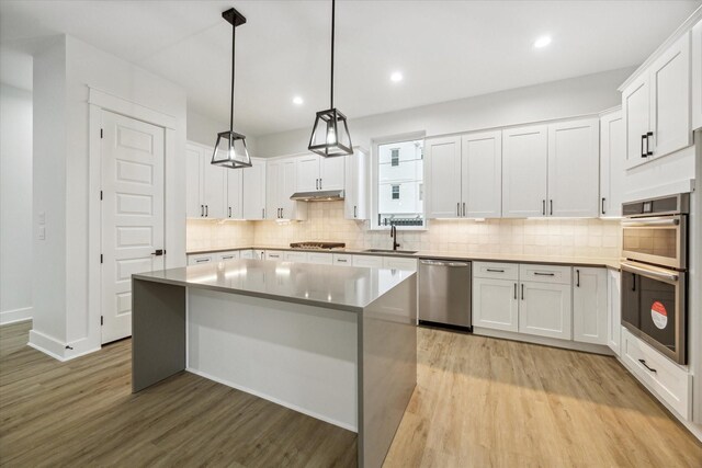 kitchen with white cabinets, appliances with stainless steel finishes, and a kitchen island