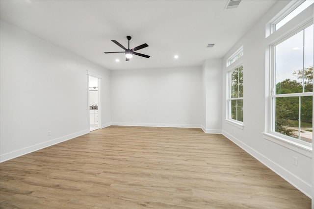 spare room featuring ceiling fan and light hardwood / wood-style floors