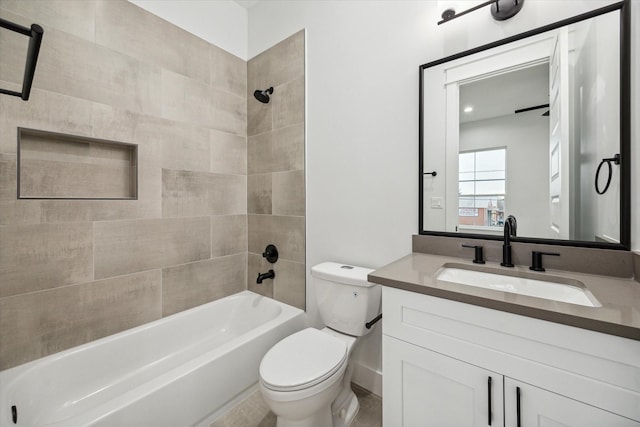 full bathroom featuring tiled shower / bath combo, toilet, and vanity