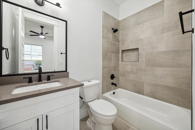 full bathroom with vanity, tiled shower / bath combo, and toilet