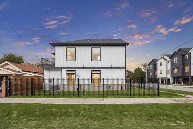 exterior space with a lawn and a balcony