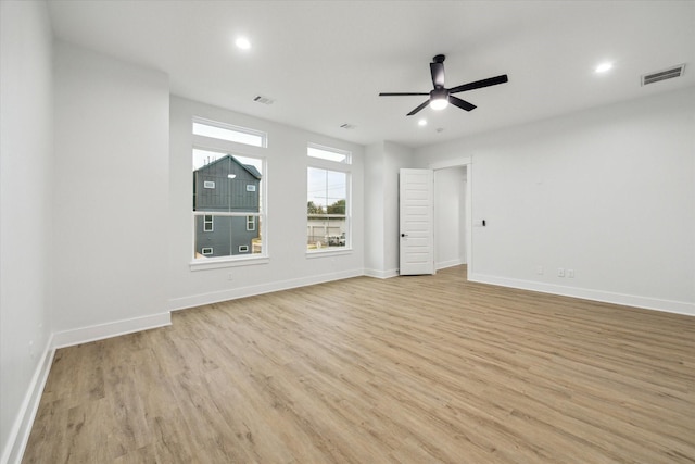 spare room featuring light hardwood / wood-style floors and ceiling fan