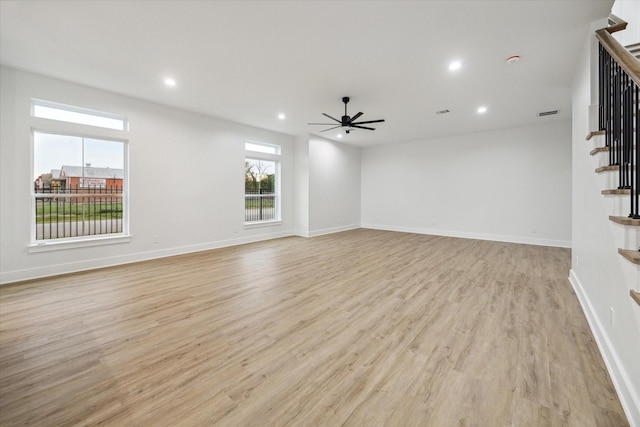 unfurnished living room featuring ceiling fan and light wood-type flooring