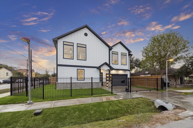 view of front of property featuring a garage and a yard