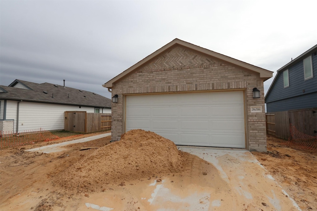 detached garage featuring fence