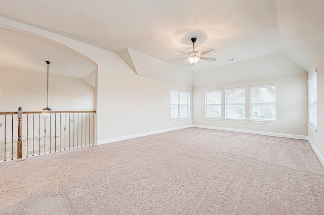 unfurnished room featuring ceiling fan, light colored carpet, and lofted ceiling