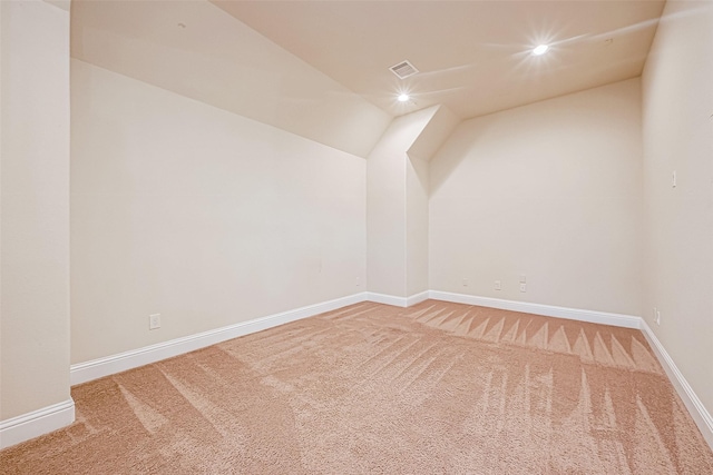 bonus room with carpet floors and vaulted ceiling