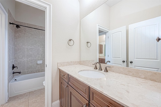 full bathroom with toilet, vanity, tile patterned floors, and tiled shower / bath