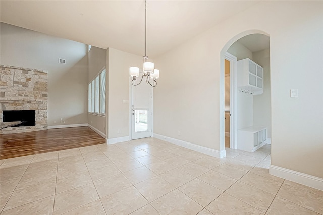 interior space with a notable chandelier, light hardwood / wood-style floors, and a fireplace