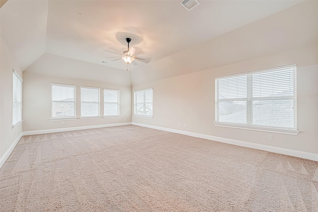 carpeted empty room featuring ceiling fan and vaulted ceiling