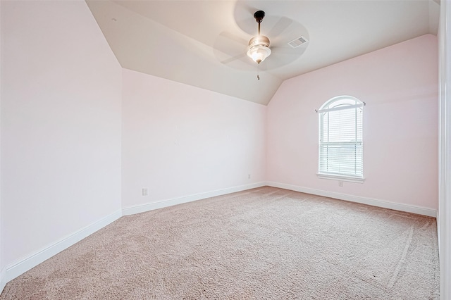 carpeted spare room with ceiling fan and lofted ceiling