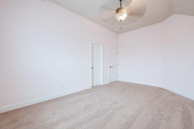 carpeted empty room featuring ceiling fan and vaulted ceiling