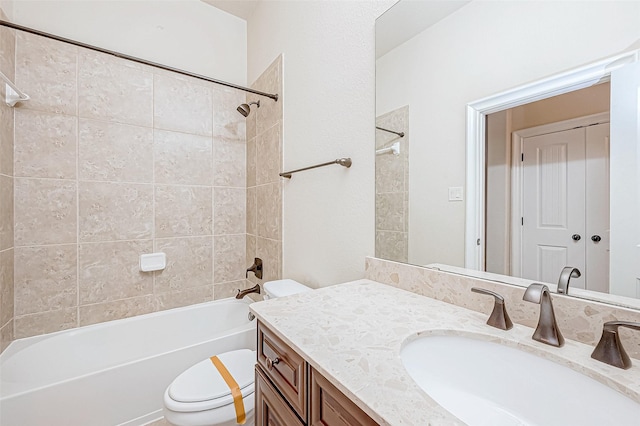 full bathroom with vanity, toilet, and tiled shower / bath combo