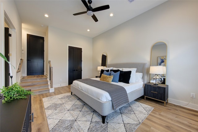 bedroom with light hardwood / wood-style floors and ceiling fan