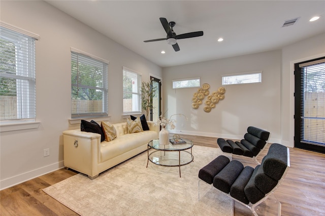 living room with ceiling fan and light wood-type flooring