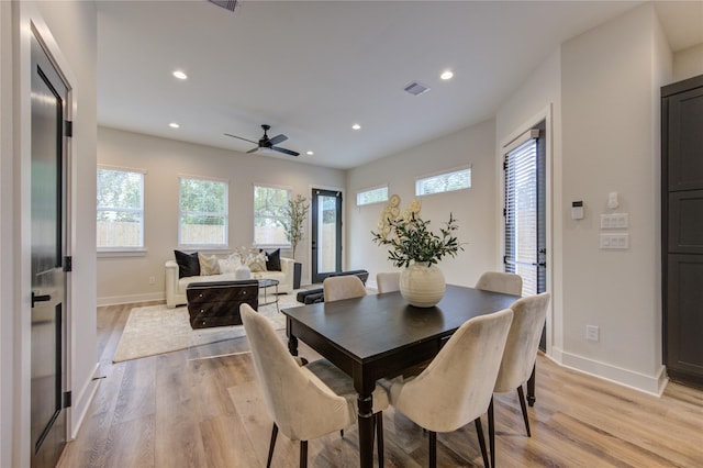 dining area with ceiling fan and light hardwood / wood-style floors