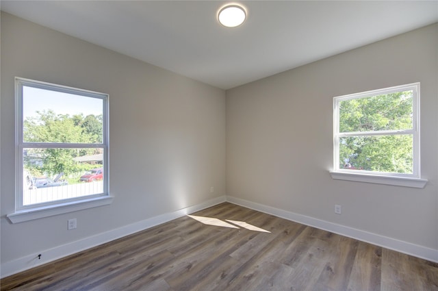 spare room with hardwood / wood-style flooring and a healthy amount of sunlight