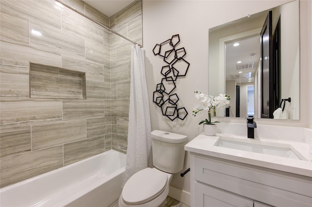 full bathroom with vanity, shower / bath combination with curtain, and toilet