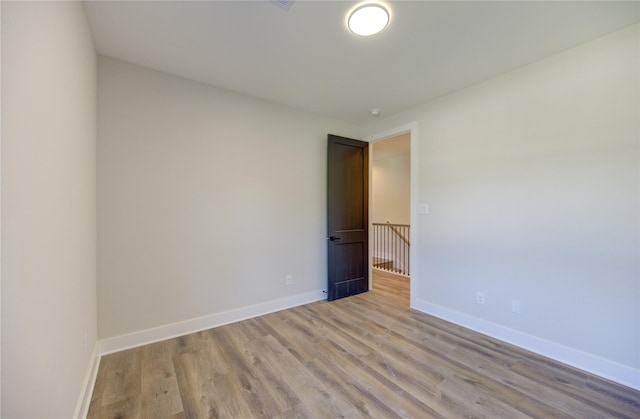 spare room featuring light wood-type flooring