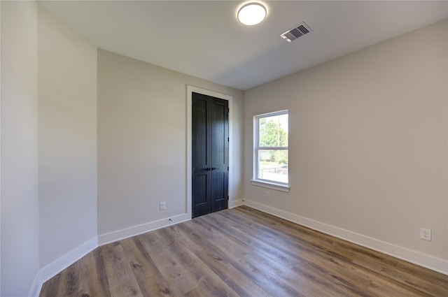 empty room featuring hardwood / wood-style flooring