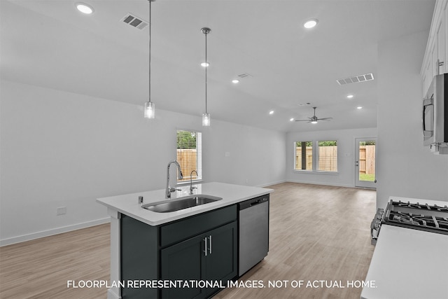 kitchen featuring sink, light hardwood / wood-style flooring, ceiling fan, appliances with stainless steel finishes, and decorative light fixtures